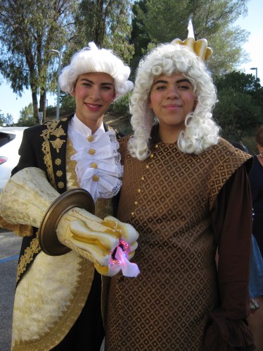 The Boy as Lumiere along with Cogsworth